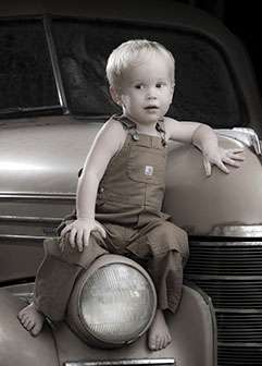Tuscaloosa, Alabama photographer's picture of a little boy in overalls on an antique car.