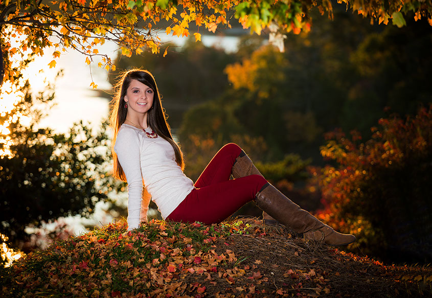 Fall senior picture with beautiful fall colors of leaves changing colors.