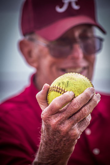 Tuscaloosa, Alabama softball coach holding softball. Taken by a Tuscaloosa photographer.