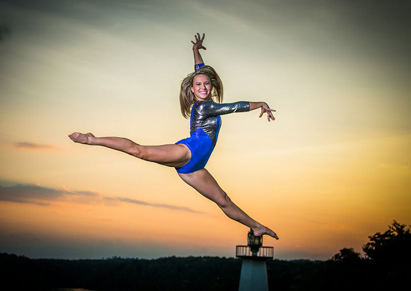 Sunset senior picture in gymnastics leotard in Tuscaloosa, Alabama.