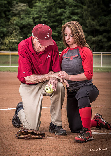 Picture of Tuscaloosa, Alabama softball coach with a girls softball player. Taken by a Tuscaloosa photographer.