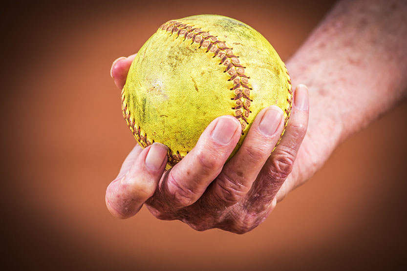 Softball in the hand of a Tuscaloosa, Alabama Softball coach. Taken by a Tuscaloosa photographer.